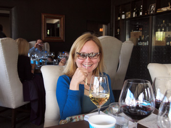 Sarah Wood, editor of <em>Edible Monterey Bay</em> grins through chocolate dessert glasses