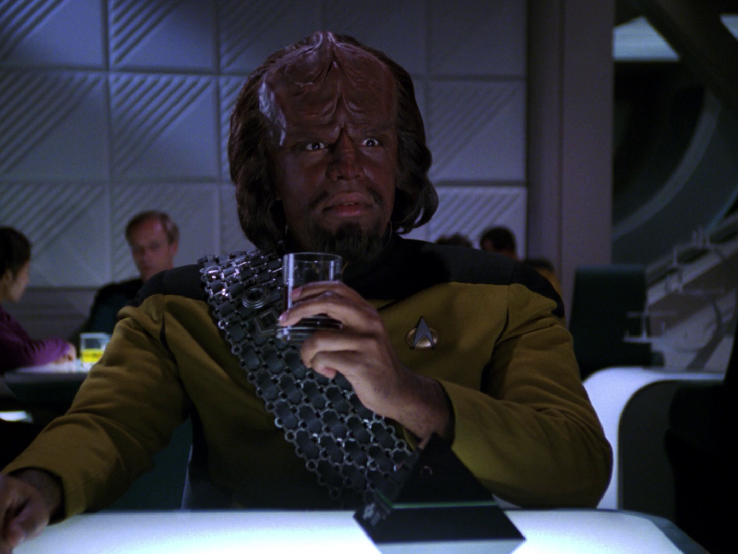 Lieutenant Commander Worf in Ten Forward looks shocked after trying his first glass of prune juice